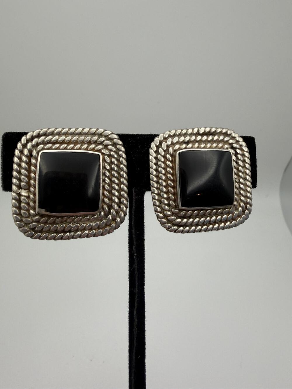 square sterling silver earrings featuring a central black onyx clip on